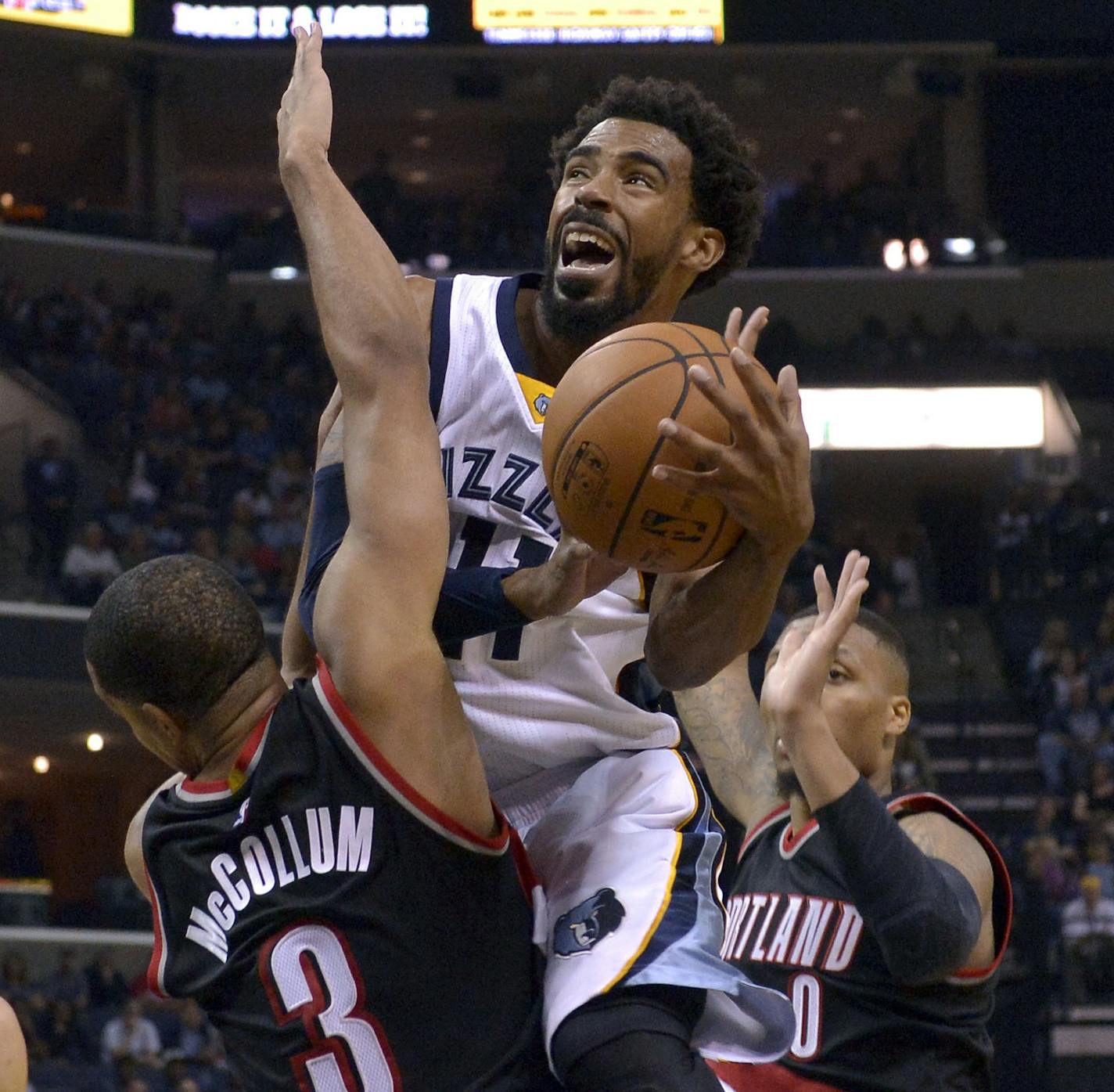 Memphis Grizzlies guard Mike Conley (11) shoots against Portland Trail Blazers guard C.J. McCollum (3) as Trail Blazers guard Damian Lillard (0) look on in the second half of an NBA basketball game Sunday, Nov. 6, 2016, in Memphis, Tenn. (AP Photo/Brandon Dill)