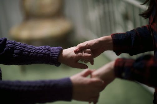 Elizabeth Wolf, right, leads her mother Nancy Brood to bed, at their home in Haddonfield, N.J., Jan 5, 2016. In 2010 Wolf, along with her husband, moved back into her childhood home to help her parents, who both suffer from dementia, expecting to arrange caregiving help and then return home to Vermont: Over five years later, she is still caring for them. (Mark Makela/The New York Times) -- -- NO SALES --