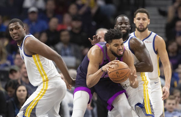 Minnesota Timberwolves center Karl-Anthony Towns (32) could not get passed Golden State Warriors forward Draymond Green (23) at Target Center Tuesday 