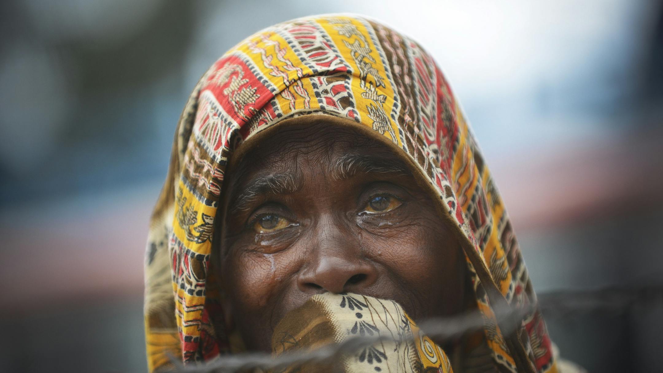A woman cries as she searches and waits for news of her missing daughter as workers and army personnel, not pictured, use heavy machinery as they work to clear the site and recover bodies of victims from the rubble of a garment factory building collapse, Monday, May 6, 2013, in Savar near Dhaka, Bangladesh. The death toll from the collapse of a shoddily built garment-factory building on April 24, in Bangladesh, continued its horrifying climb, reaching at least 630 on Monday with little sign of w