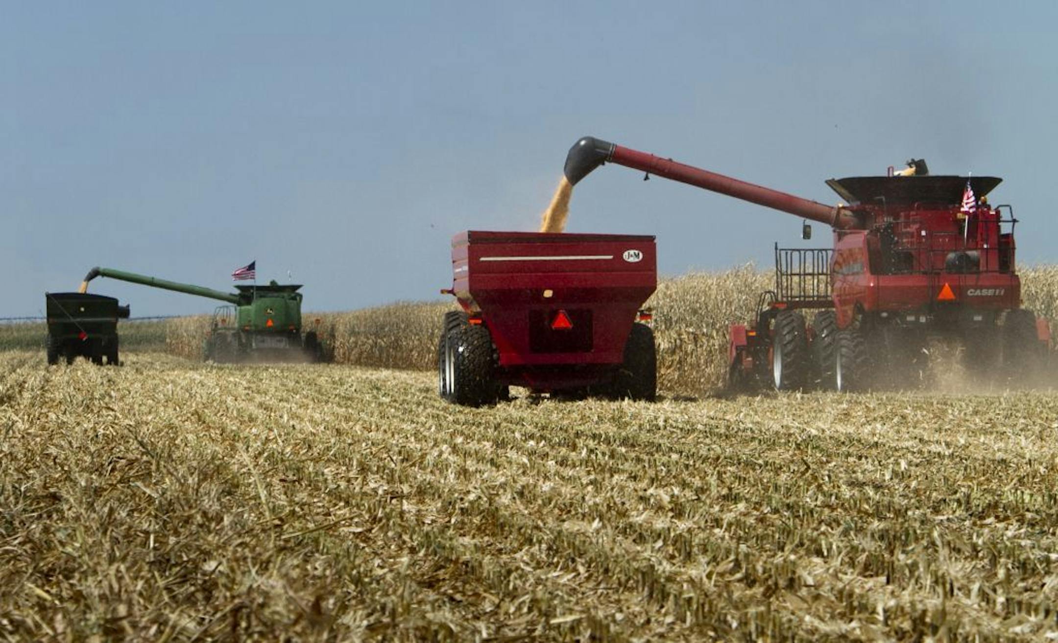 FILE - In this Sept. 15, 2010, file photo, combines, costing several hundred thousand dollars each, harvest a field during a corn harvesting demonstration at the Husker Harvest Days fair, in Grand Island, Neb. A program that puts billions of dollars in the pockets of farmers whether or not they plant a crop may disappear with hardly a protest from farm groups and the politicians who look out for their interests. The Senate is expected to begin debate the week of June 4, 2012, on a five-year farm