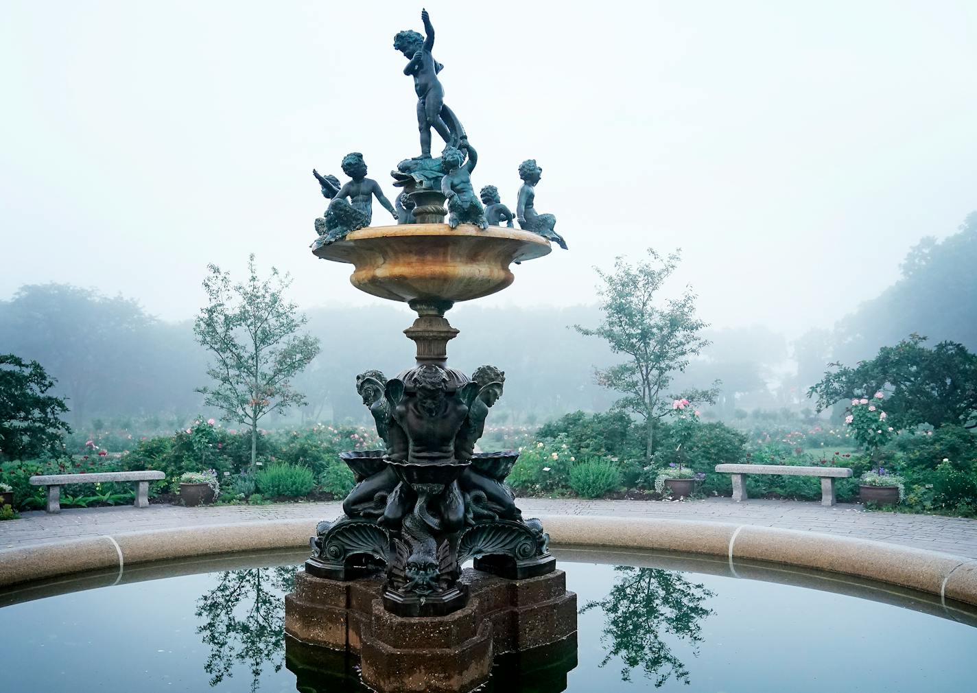 Heffelfinger fountain in the Lyndale Park Rose Garden in Minneapolis surrounded by morning mist.