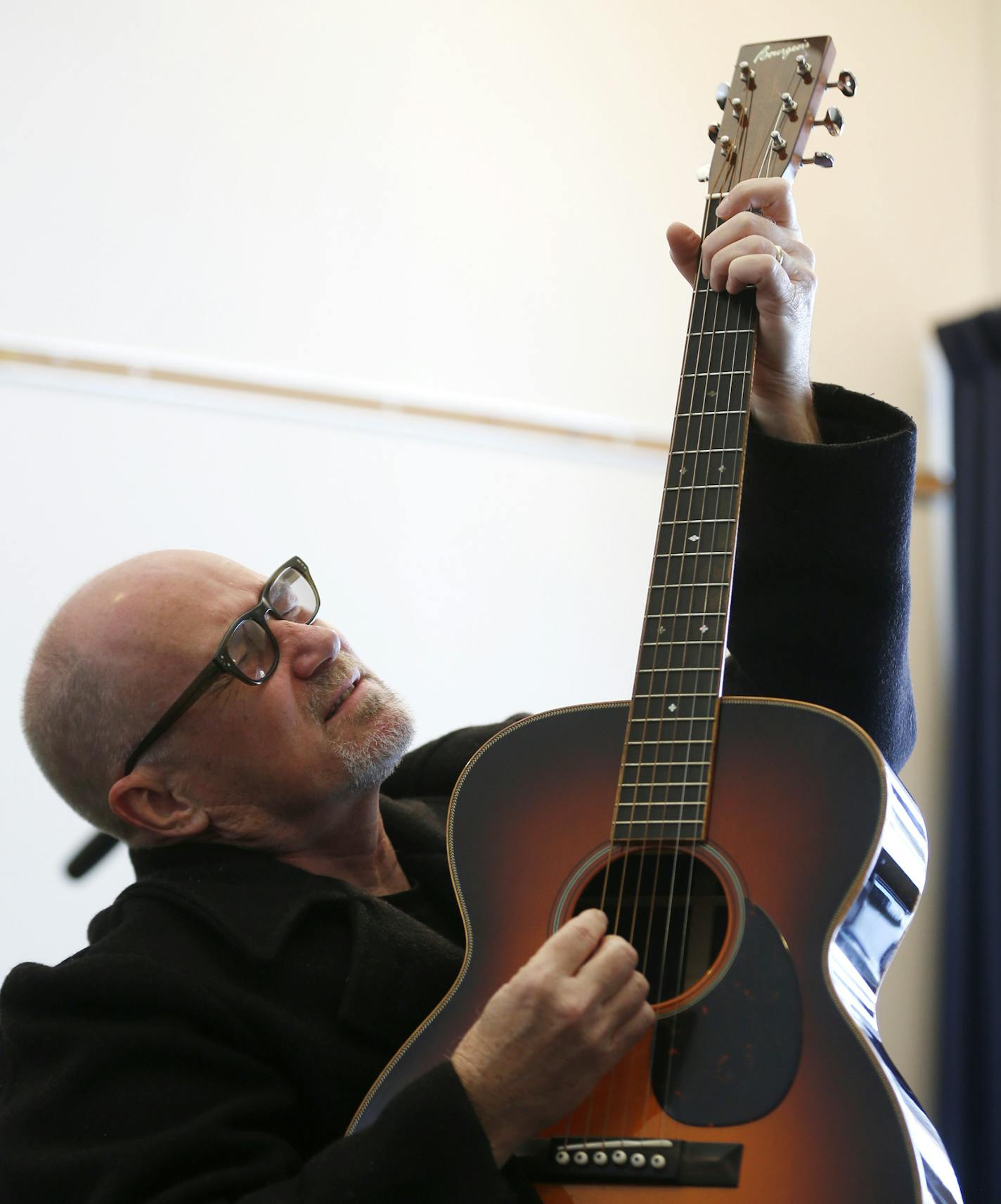 Singer and songwriter Marshall Crenshaw plays the guitar while working on a song with Iraq combat veteran Adan Olid during the Songwriting With Soldiers retreat at the Carey Institute for Global Good on Saturday, Nov. 15, 2014, in Rensselaerville, N.Y. Olid is one of more than 100 veterans who have turned their stories into sometimes affectingly personal songs at Songwriting With Soldiers retreats. (AP Photo/Mike Groll)