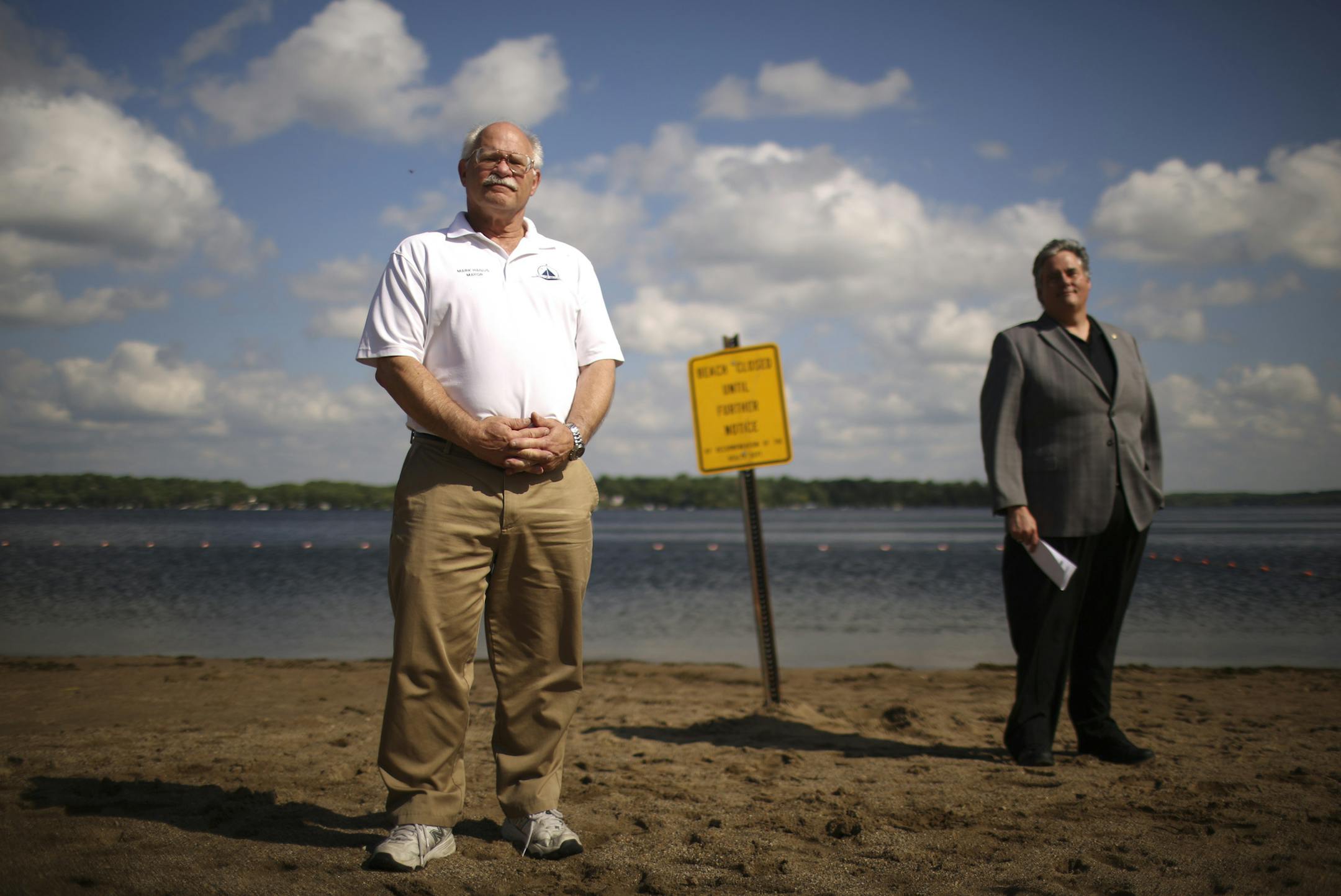 Mound Mayor Mark Hanus at Surfside Park Monday afternoon along with state senator Dave Osmek on one of the beaches that was closed because of an E. coli bacteria risk from the raw sewage. ] JEFF WHEELER ‚Ä¢ jeff.wheeler@startribune.com The mayor of Mound blames the Met Council for his city having to pump untreated sewage into storm sewers feeding into Lake Minnetonka after heavy rains over the weekend. He was photographed in Mound Monday, June 2, 2014, at Surfside Park along wit