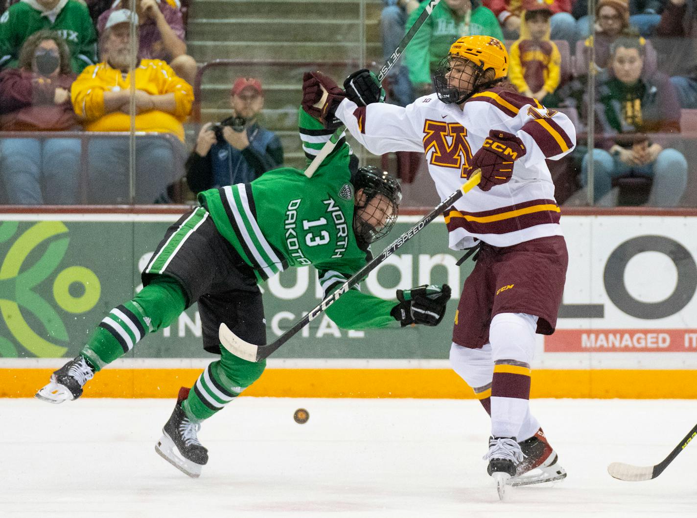 North Dakota forward Carson Albrecht (13) is hit by Minnesota forward Brody Lamb (17) in the first period Friday, Oct. 21, 2022 at 3M Arena at Mariucci in Minneapolis. ]