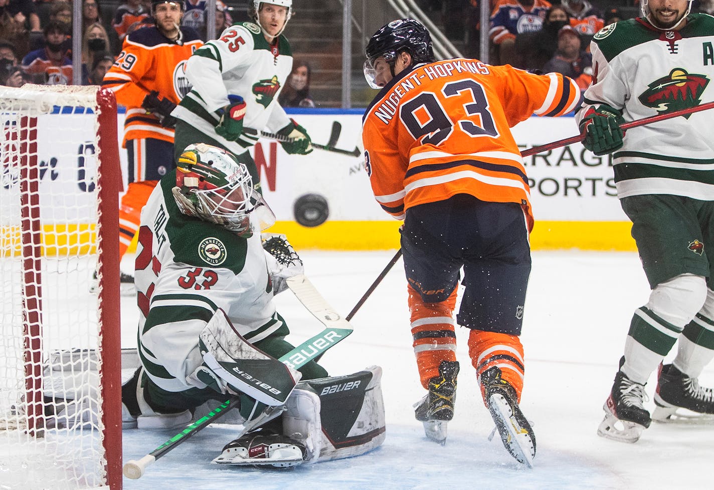 Minnesota Wild goalie Cam Talbot (33) makes a save on Edmonton Oilers' Ryan Nugent-Hopkins (93) during the second period of an NHL hockey game Tuesday, Dec. 7, 2021, in Edmonton, Alberta. (Jason Franson/The Canadian Press via AP)