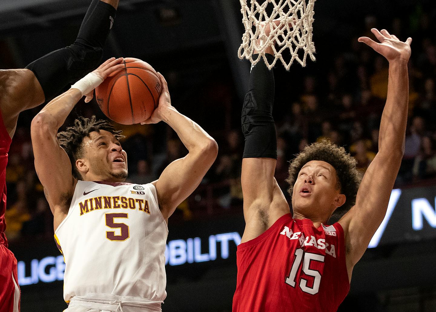 Amir Coffey is defended by Isaiah Roby in the first half