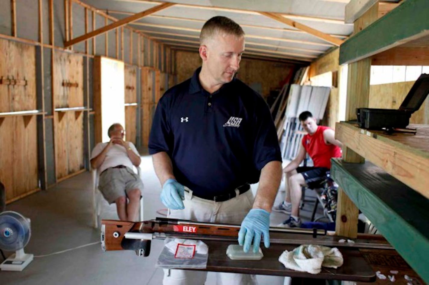 After shooting practice, U.S. Olympic shooting member Eric Uptagrafft cleans his rifle in Elk River, Minn. Tuesday, July 3, 2012. ] MEGAN TAN/ STAR TRIBUNE•megan.tan@startribune.com.