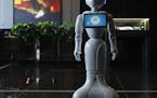 In this Nov. 15, 2017, photo, a robot named Pepper stands in the lobby of the Mandarin Oriental in Las Vegas. Pepper is programmed to interact with gu