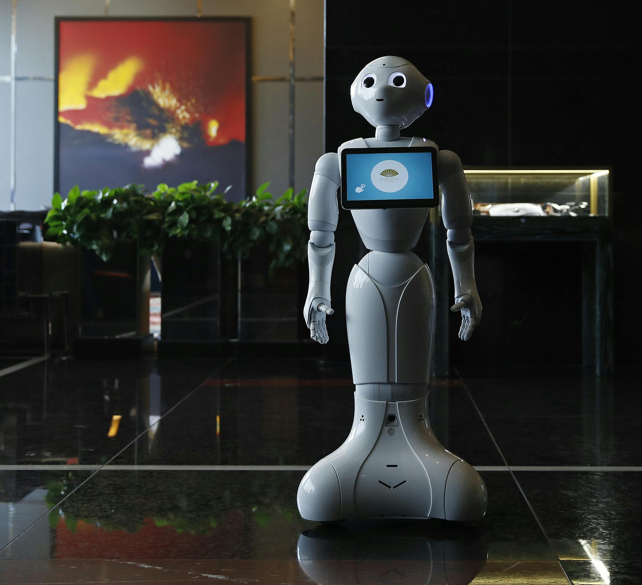 In this Nov. 15, 2017, photo, a robot named Pepper stands in the lobby of the Mandarin Oriental in Las Vegas. Pepper is programmed to interact with guests and answer pre-programmed questions. (AP Photo/John Locher)