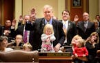Rep. Dean Urdahl was among the House members sworn in with his grandchildren Mason, seated, Bernadette, 2 and Veronica, 1, held by Karen Urdahl, Dean'