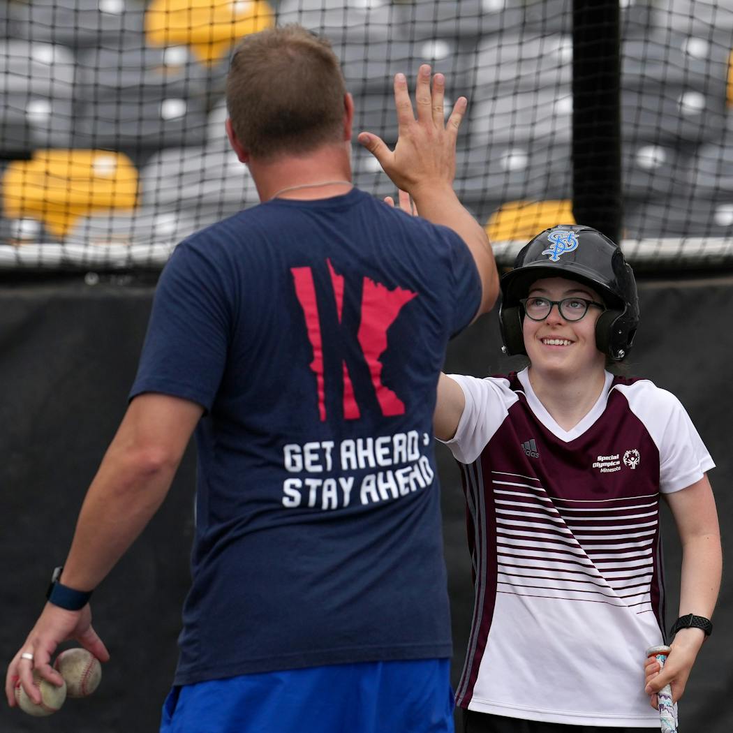 Ellen Maguire of Vadnais Heights got a high five from manager Toby Gardenhire after she connected with the ball.