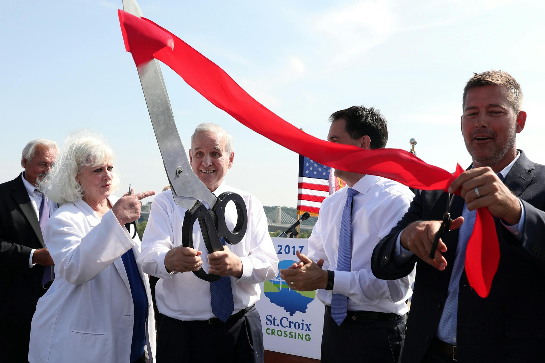 Minnesota Gov. Mark Mark Dayton looked on with laugher after his attempt at cutting the ribbon with oversized scissors was unsuccessful.