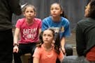 Three actors playing the lead, L to r, Lillian Hochman, Audrey Mojica and Sofia Salmela, and listened as director Peter Brosius and China Brickey work