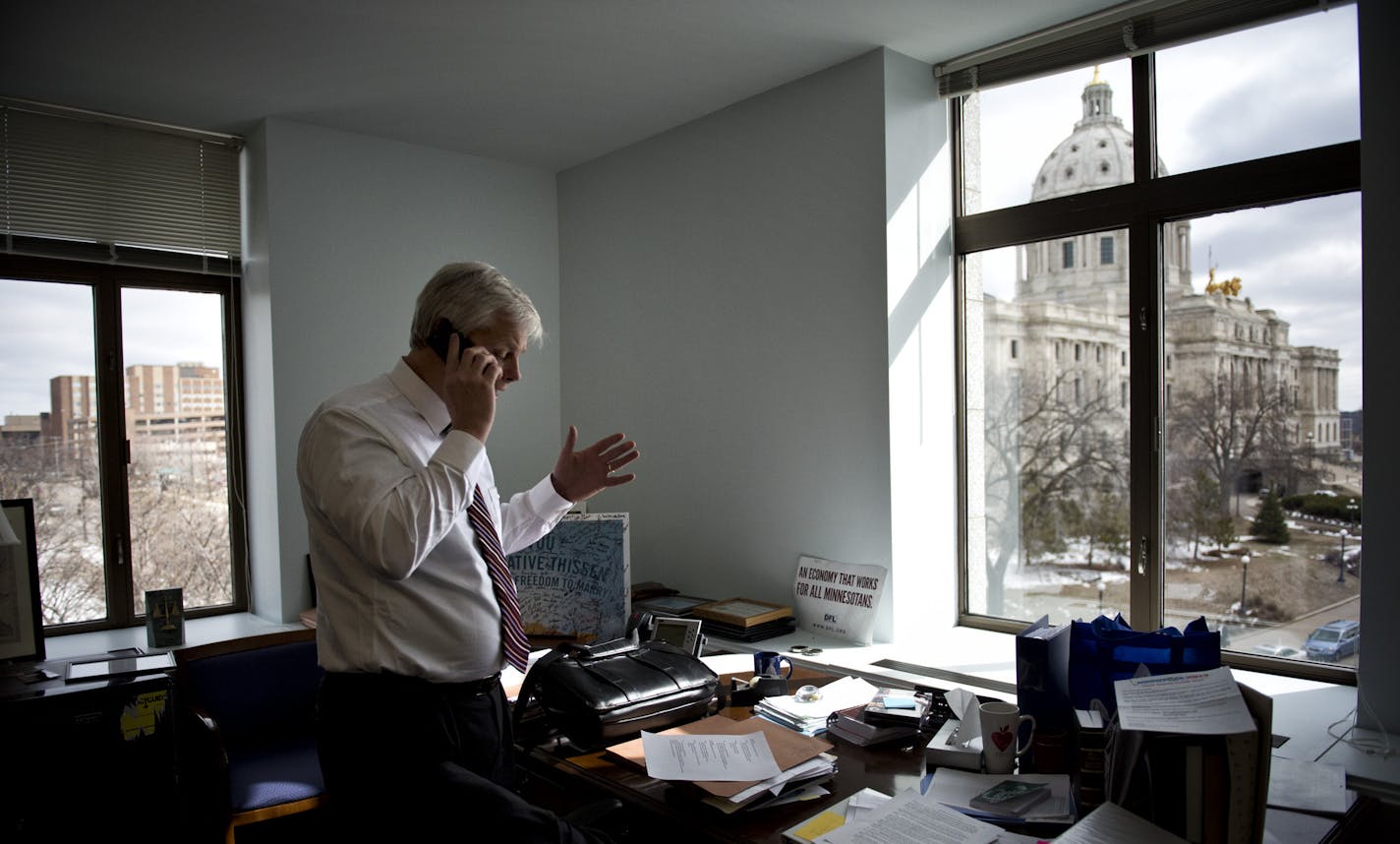 From his office in the State Office Building, House Speaker Paul Thissen took part in a series of radio interviews by phone. Below, political analysis and toy tractors mix.