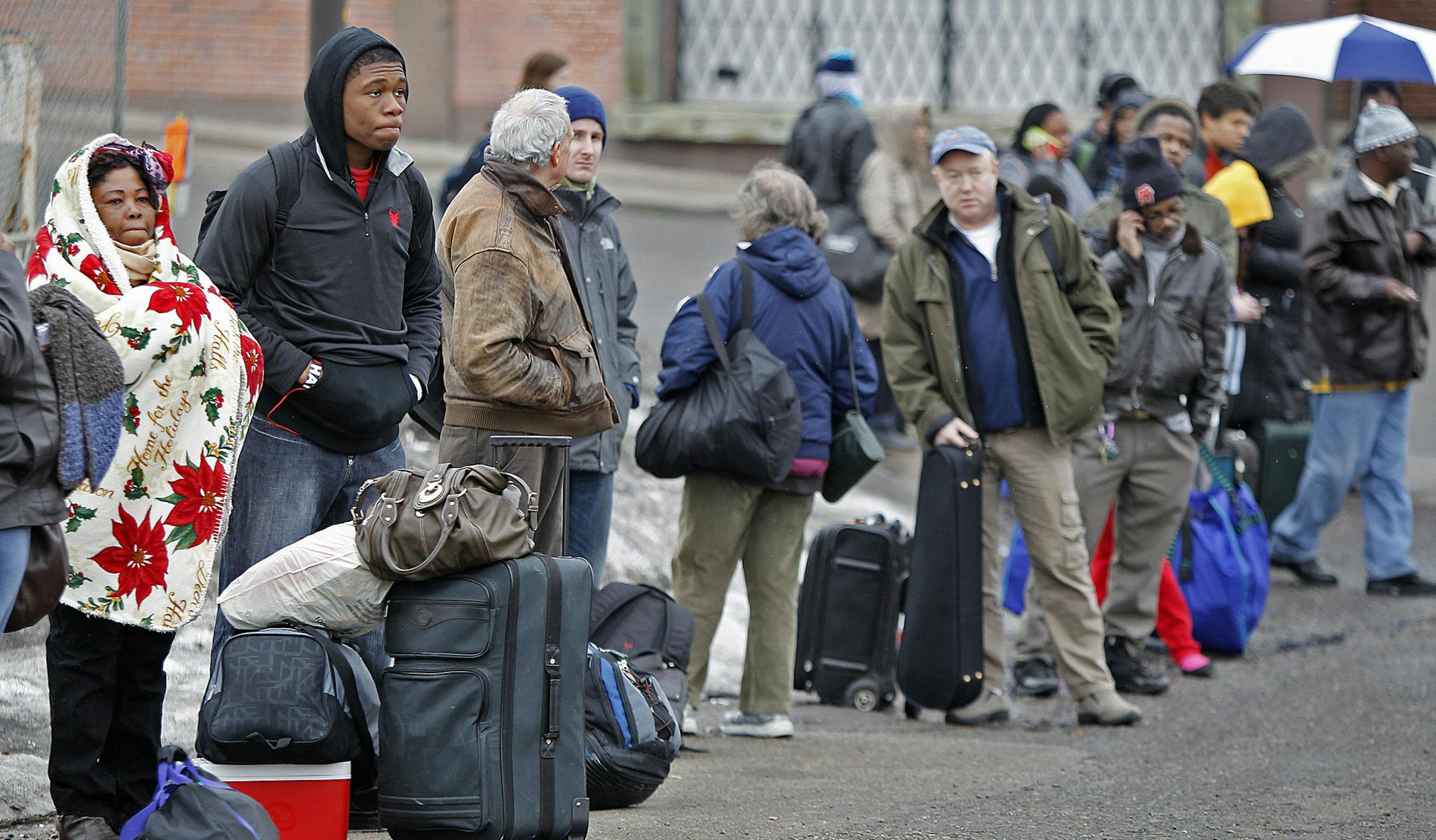 Passengers waited in line at the Megabus pick-up location near the corner of Washington and Chicago Avenues in downtown Minneapolis, MN, Friday, March 29, 2013. (ELIZABETH FLORES/STAR TRIBUNE) ELIZABETH FLORES &#x2022; eflores@startribune.com
