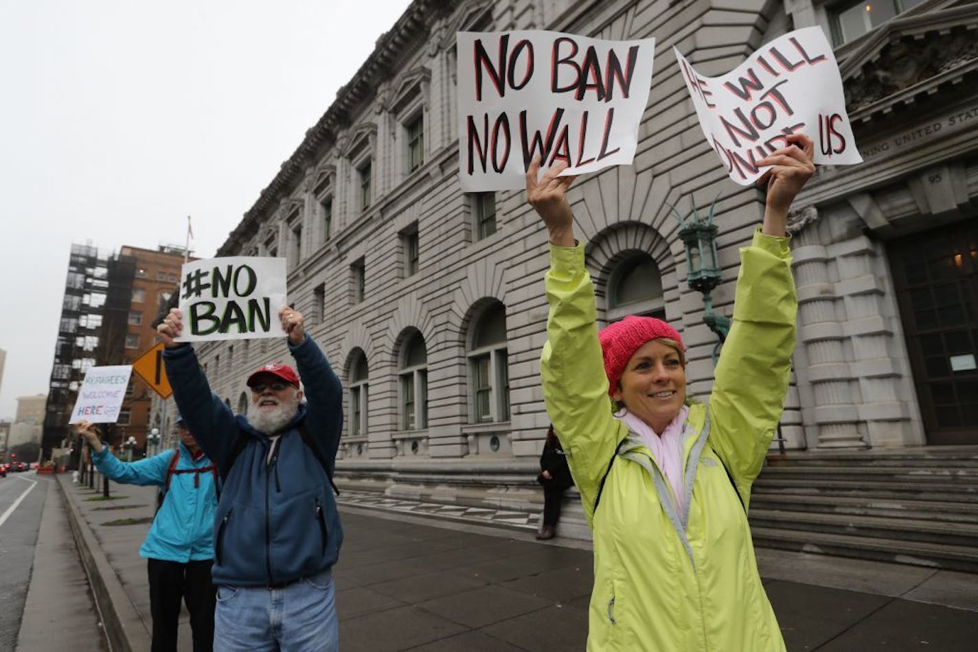 Protesters gather outside the U.S. Court of Appeals for the Ninth Circuit, which is preparing to hear arguments over whether to lift a stay on enforcement of President Donald Trump�s travel ban, in San Francisco, Feb. 7, 2017. The appellate on Tuesday heard an hourlong oral argument on whether to reinstate Trump�s travel ban.