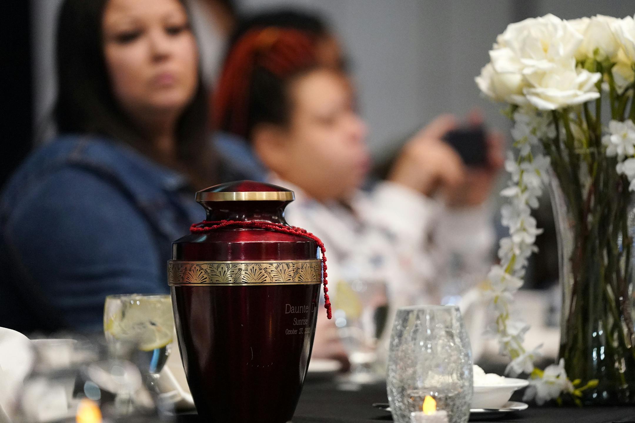 Daunte Wright's urn sits at his family's table during an event to mark one year at the Earle Brown Heritage Center in Brooklyn Center, Minn.