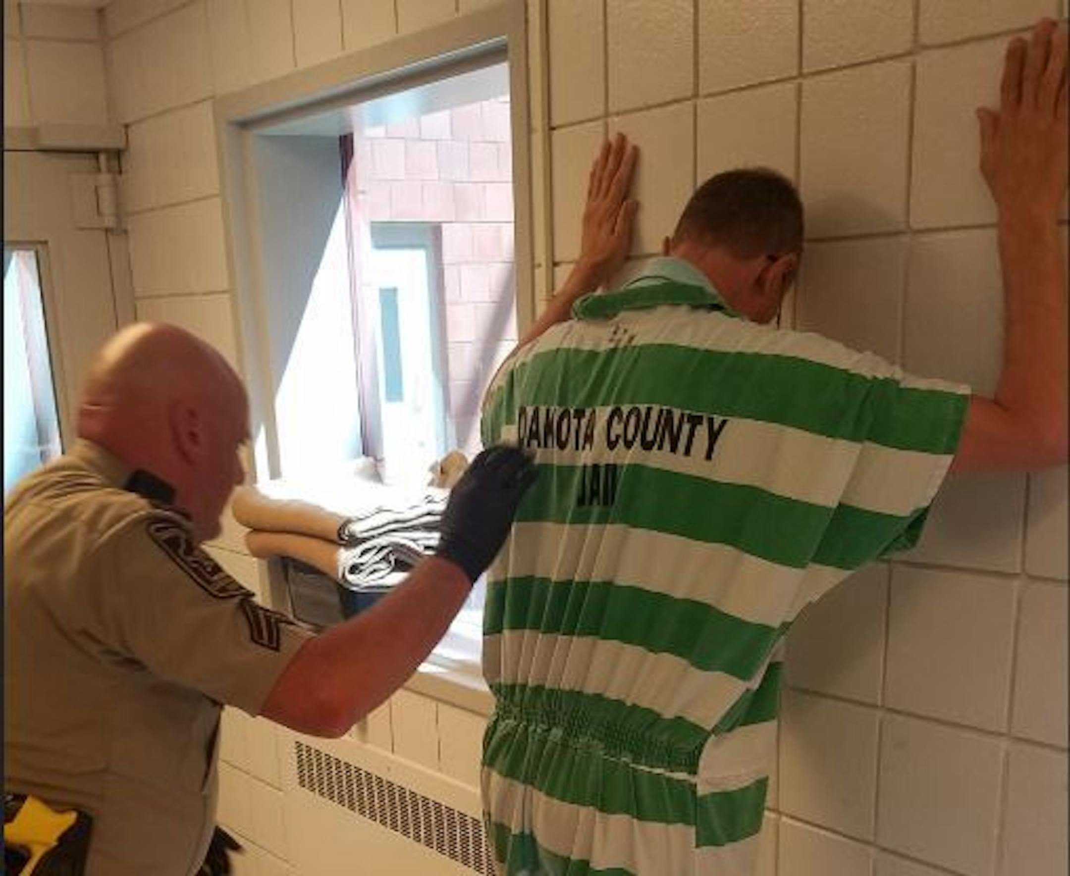 Dakota County Corrections Officer Tim Parker performs a patdown similar to one he would conduct on DWI offender before placing them in a jail cell.