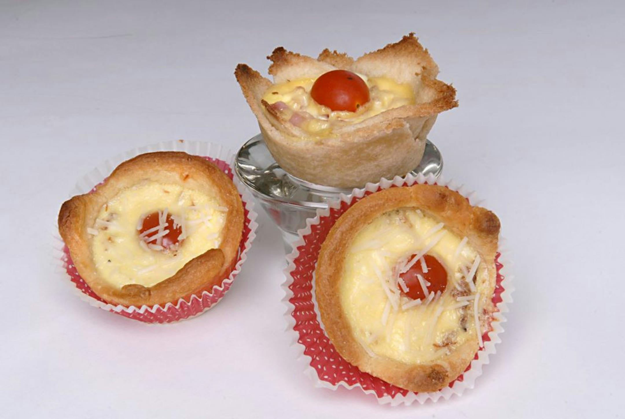 Using a pre-made bread dough, such as refrigerated crescent roll dough, makes egg tarts an easier dish to make.