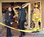 Emergency personnel assessed the scene Saturday morning after a car was driven into the front of a store in downtown Excelsior. Two people inside the 
