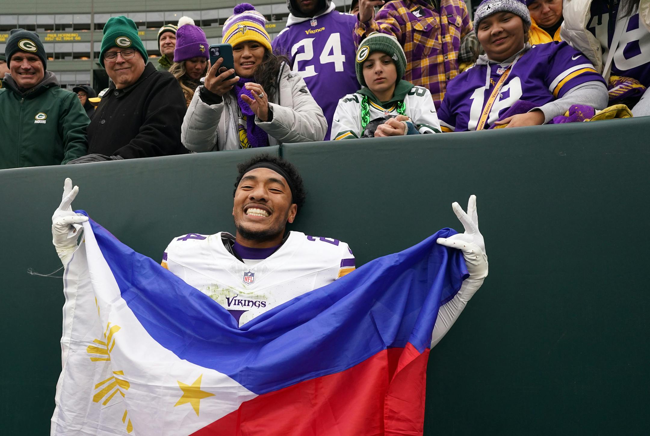 Minnesota Vikings safety Camryn Bynum (24) celebrates with a Philippines flag following an NFL game between the Minnesota Vikings and the Green Bay Packers Sunday, Oct. 29, 2023 at Lambeau Field in Green Bay, Wis. ] ANTHONY SOUFFLE • anthony.souffle@startribune.com