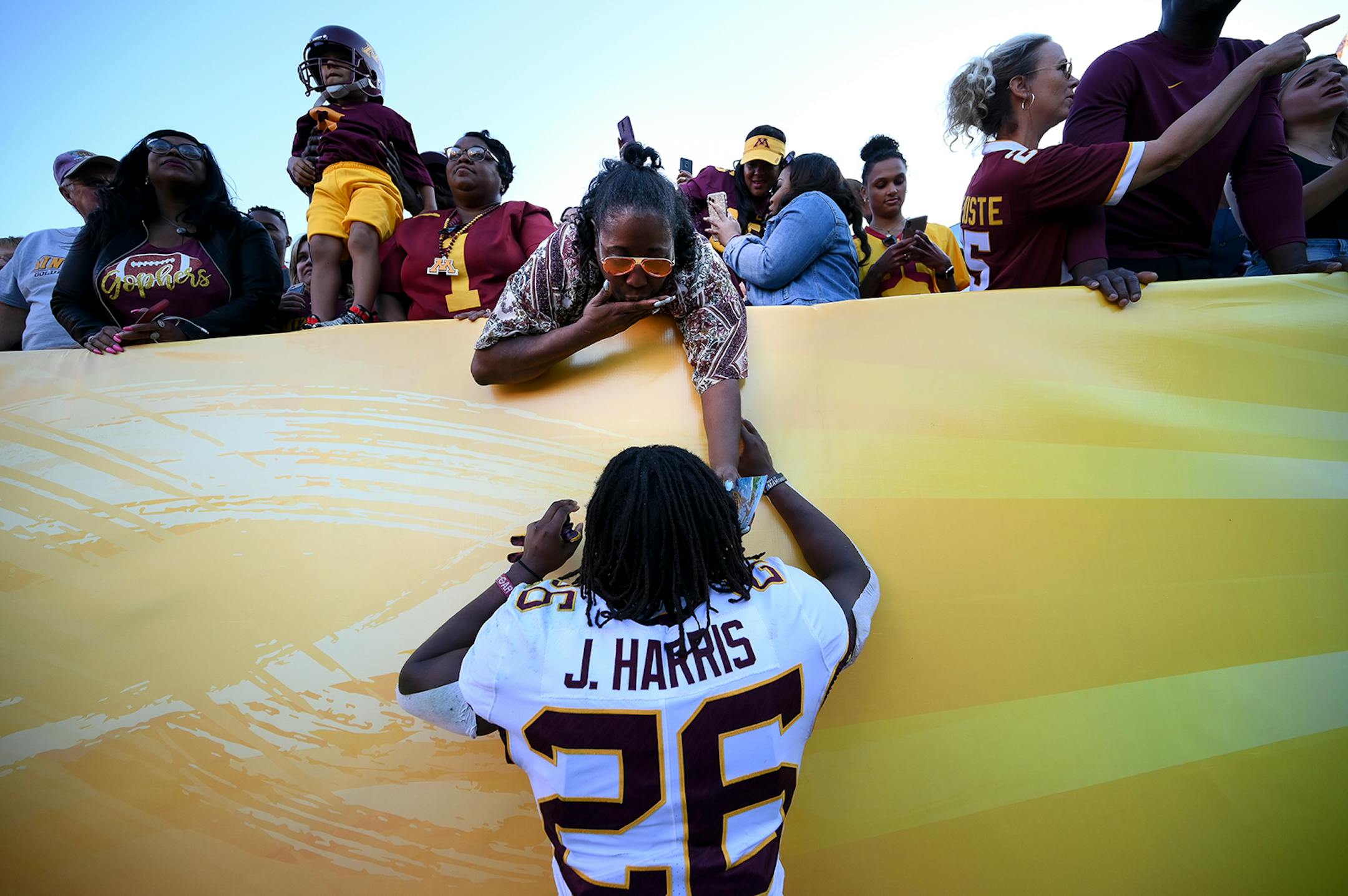 Minnesota Gophers defensive back Justus Harris (26) shared a moment with his mother, Andrea, after his team's win against the Auburn Tigers in the Outback Bowl Wednesday.