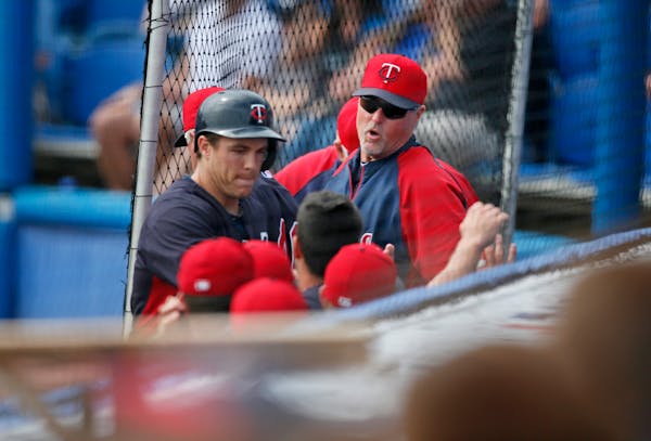 Twins hitting coach Tom Brunansky, right, offered encouragement during spring training.