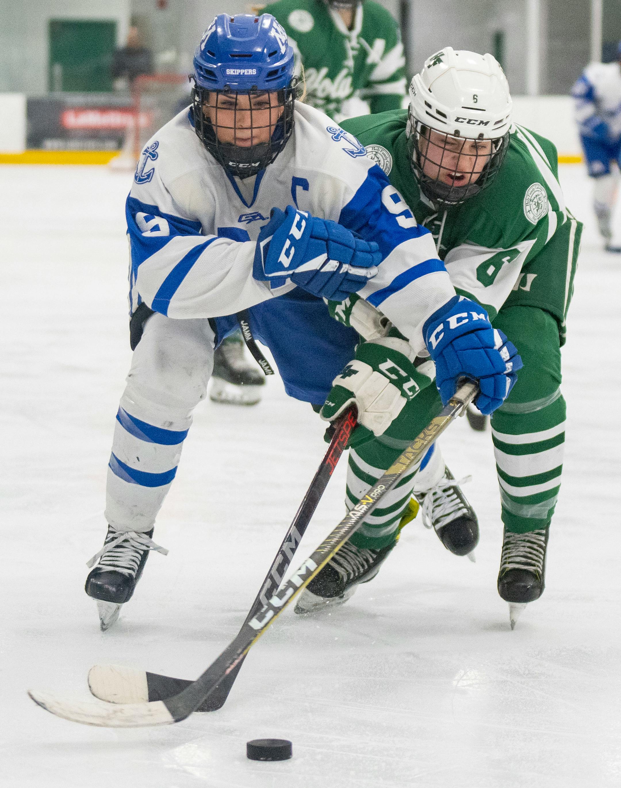 Minnetonka forward Ava Lindsay (9) and Holy Family defender Maielle Schugel (6) fight for the puck during the second period.