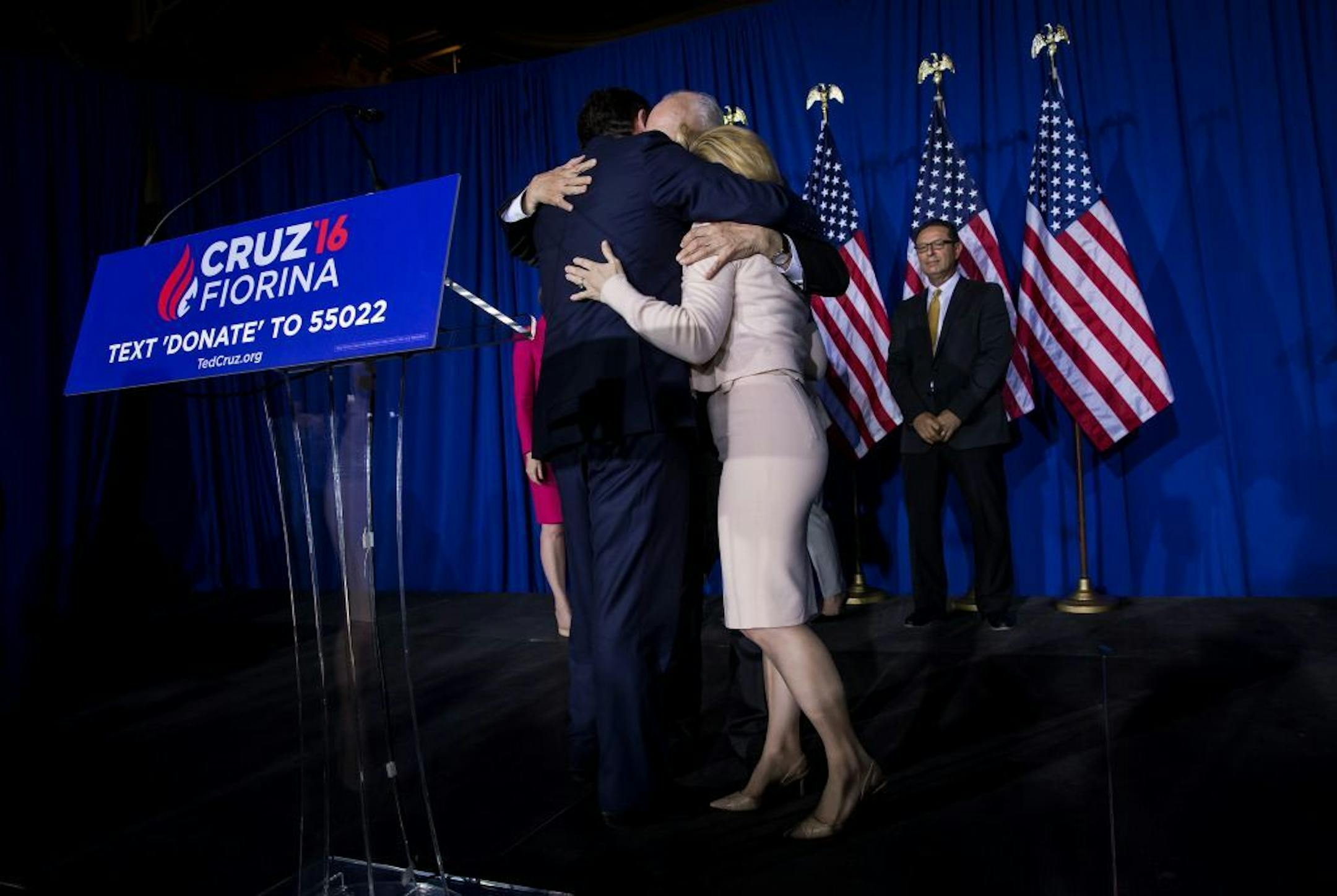 Sen. Ted Cruz hugged his father, Rafael, and wife, Heidi, after announcing that he would suspend his presidential campaign Tuesday night at a rally in Indianapolis.