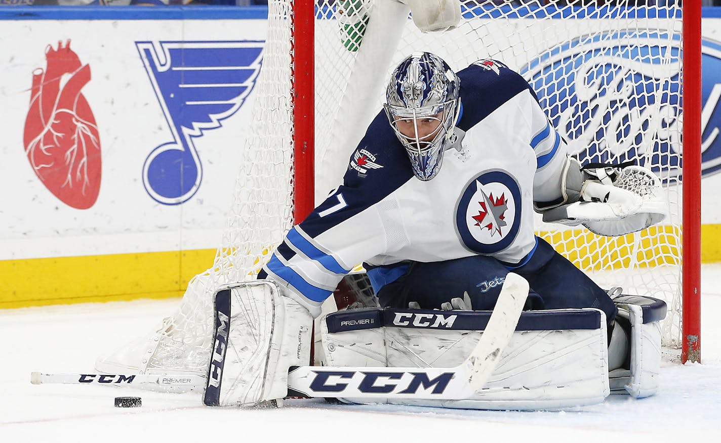 Winnipeg Jets goaltender Connor Hellebuyck stops a shot during the second period of an NHL hockey game against the St. Louis Blues, Friday, Feb. 23, 2018, in St. Louis. (AP Photo/Billy Hurst)