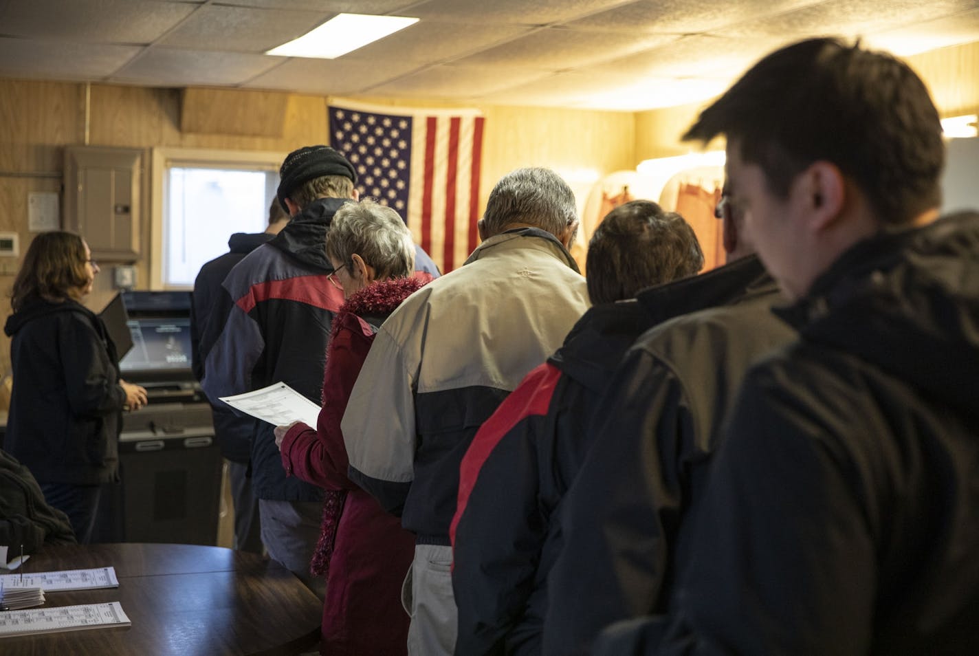 A long line formed at the tiny one room of Douglas Town Hall on Election Day on Tuesday, November 6, 2018, in the area of Douglas Township, Minn. The town hall has 494 registered voters and has a steady flow of people throughout the day. It also has a sign out front that says "If you need curbside voting honk three times and we will bring you a ballot" meant for elderly or disabled people.