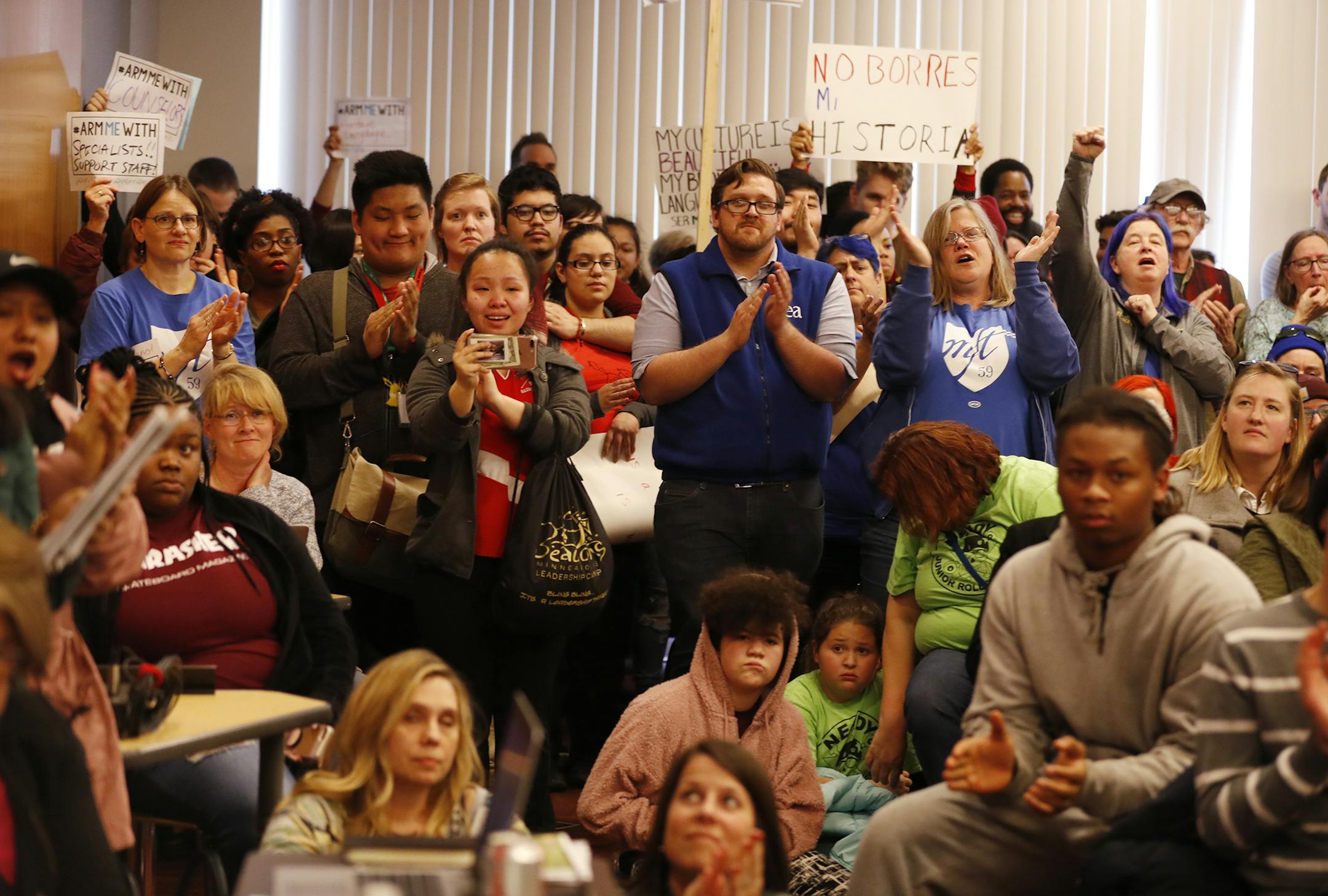 The crowd cheers a speaker during the public comment period. ] LEILA NAVIDI ï leila.navidi@startribune.com BACKGROUND INFORMATION: Parents, students, staff and teachers upset about proposed budget cuts to their individual schools speak during a public comment period at a Minneapolis School Board meeting at the Davis Center in Minneapolis on Tuesday, April 10, 2018.