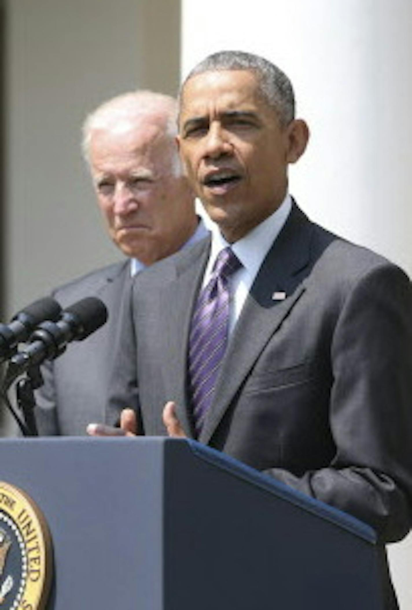 President Barack Obama delivers a statement about relations with Cuba, while Vice President Joe Biden looks on, in the Rose Garden at the White House, in Washington, July 1, 2015. Obama announced Wednesday that the U.S. and Cuba have come to an agreement to reopen embassies in each other&#xed;s capitals, formally restoring diplomatic relations. (Doug Mills/The New York Times)