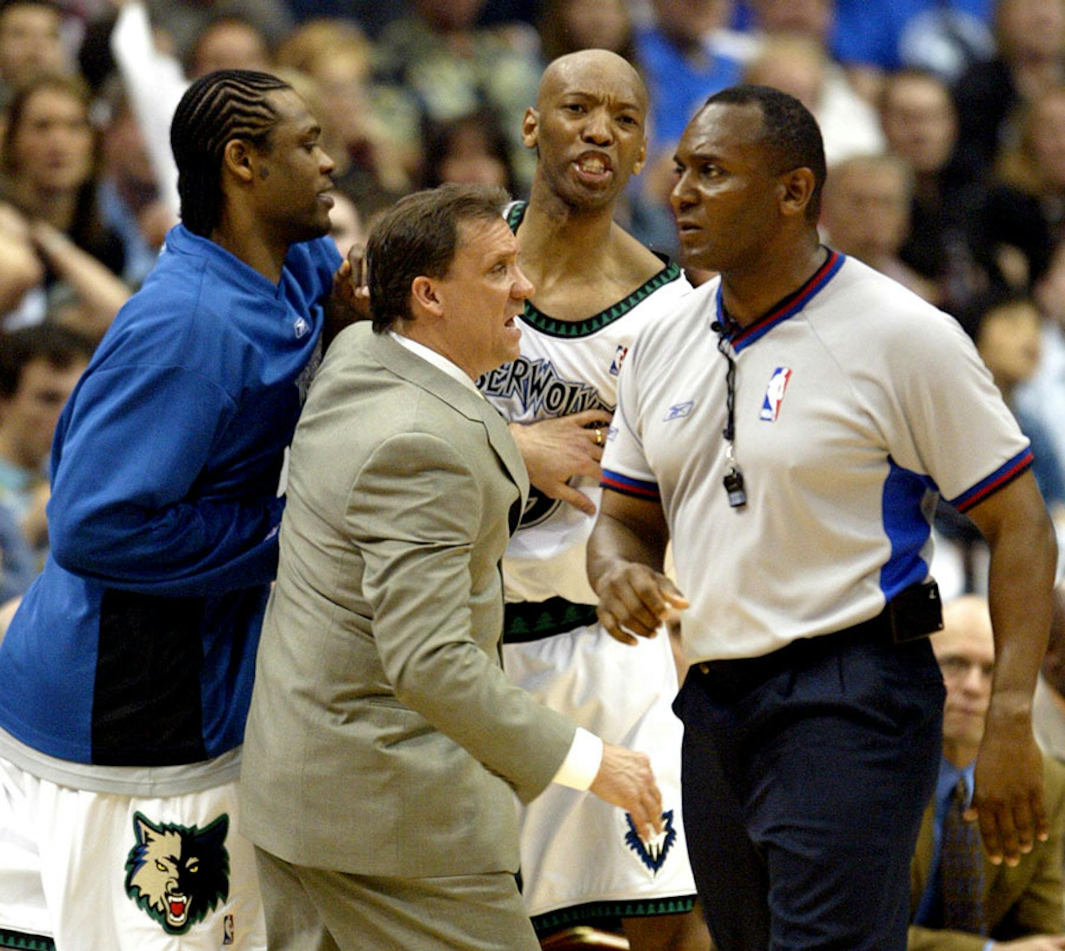 Timbewolves head coach Flip Saunders and Latrell Sprewell restrain Sam Cassell after he was given a technical foul in the 2nd quarter. May 8, 2004