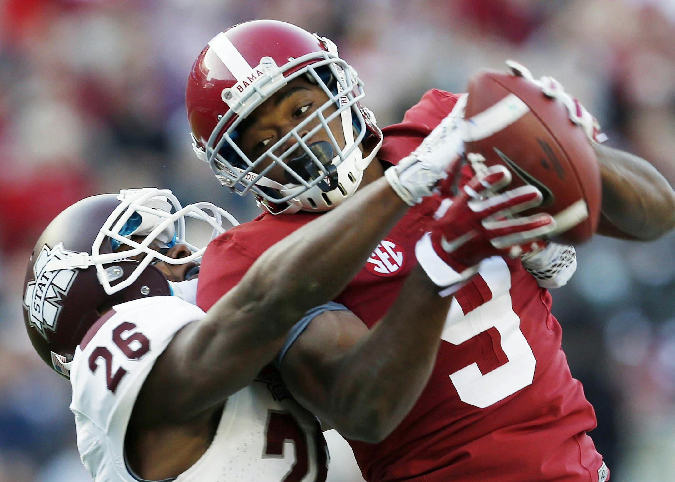 Alabama wide receiver Amari Cooper (9) catches a 50-yard pass against Mississippi State defensive back Kendrick Market (26) in the first half of an NCAA college football game on Saturday, Nov. 15, 2014, in Tuscaloosa, Ala. (AP Photo/Butch Dill)