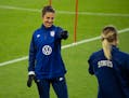 USWNT forward Carli Lloyd laughed and pointed to defender Abby Dahlkemper during a drill while they warmed up at the start of practice Monday, Oct. 25