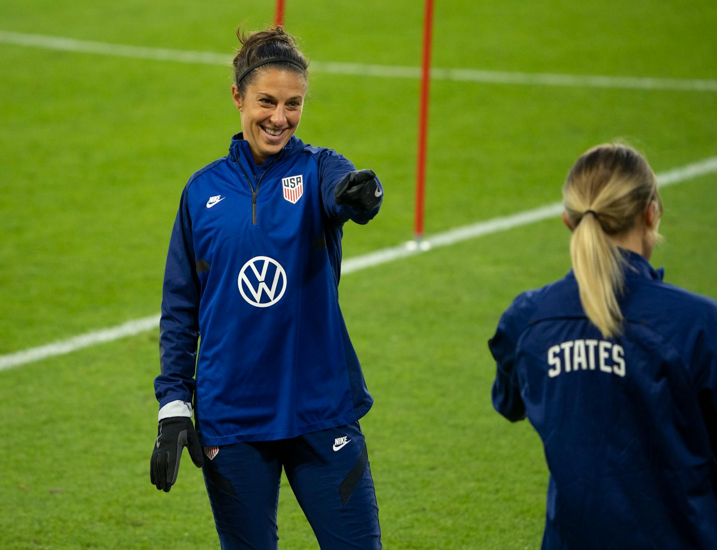 USWNT forward Carli Lloyd laughed and pointed to defender Abby Dahlkemper during a drill while they warmed up at the start of practice Monday, Oct. 25, 2021 in St. Paul, Minn. The U.S. Women's National Soccer Team worked out at Allianz Field Monday evening Monday, Oct. 25, 2021 in St. Paul. ] JEFF WHEELER • Jeff.Wheeler@startribune.com