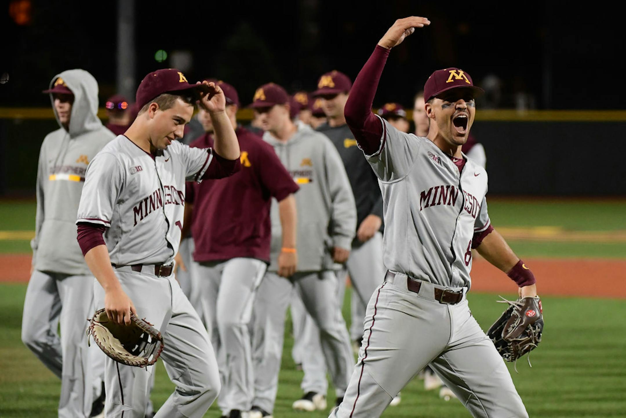 Minnesota third baseman Micah Coffey (8) celebrated with teammates after their 3-2 victory over UCLA