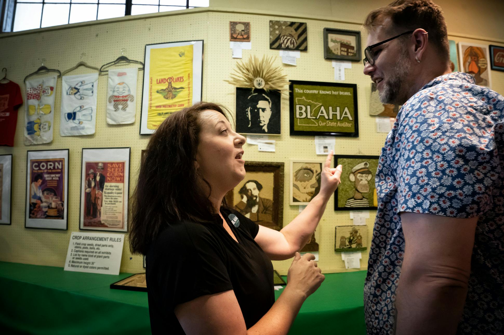 DFL State Auditor Julie Blaha talked to Ross Elfline on Aug. 26 at the crop art display in the Agriculture Building at the State Fair. Blaha has an entry there.