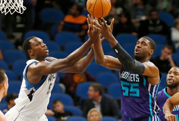 Timberwolves center Gorgui Dieng, left, and the Hornets' Roy Hibbert battled for a rebound during the first quarter at Target Center on Friday.