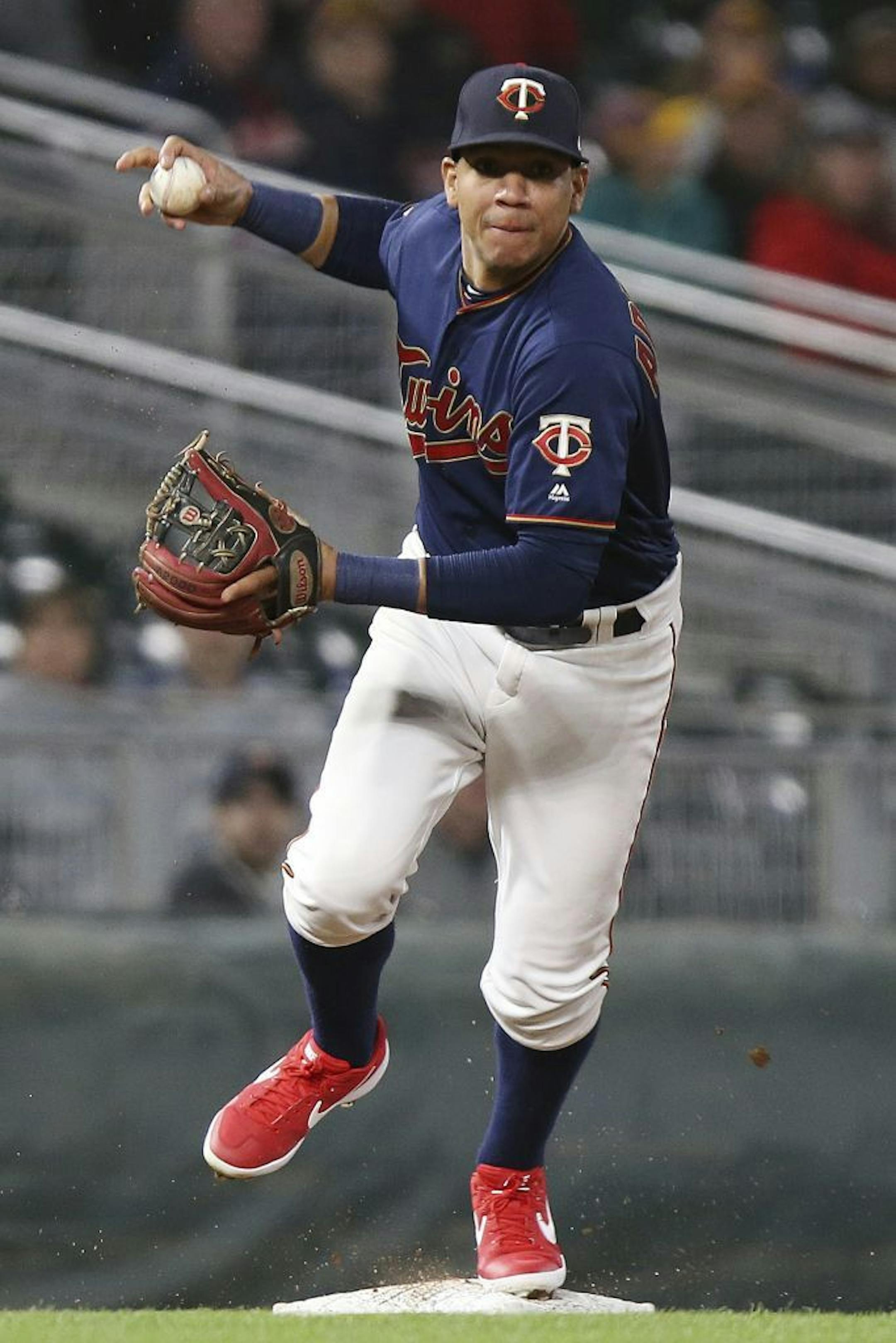 Minnesota Twins' Ehire Adrianza gets an out at third and lines up to throw to first base against the Detroit Tigers in the ninth inning of a baseball game Friday, May 10, 2019, in Minneapolis. The Twins won 6-0.