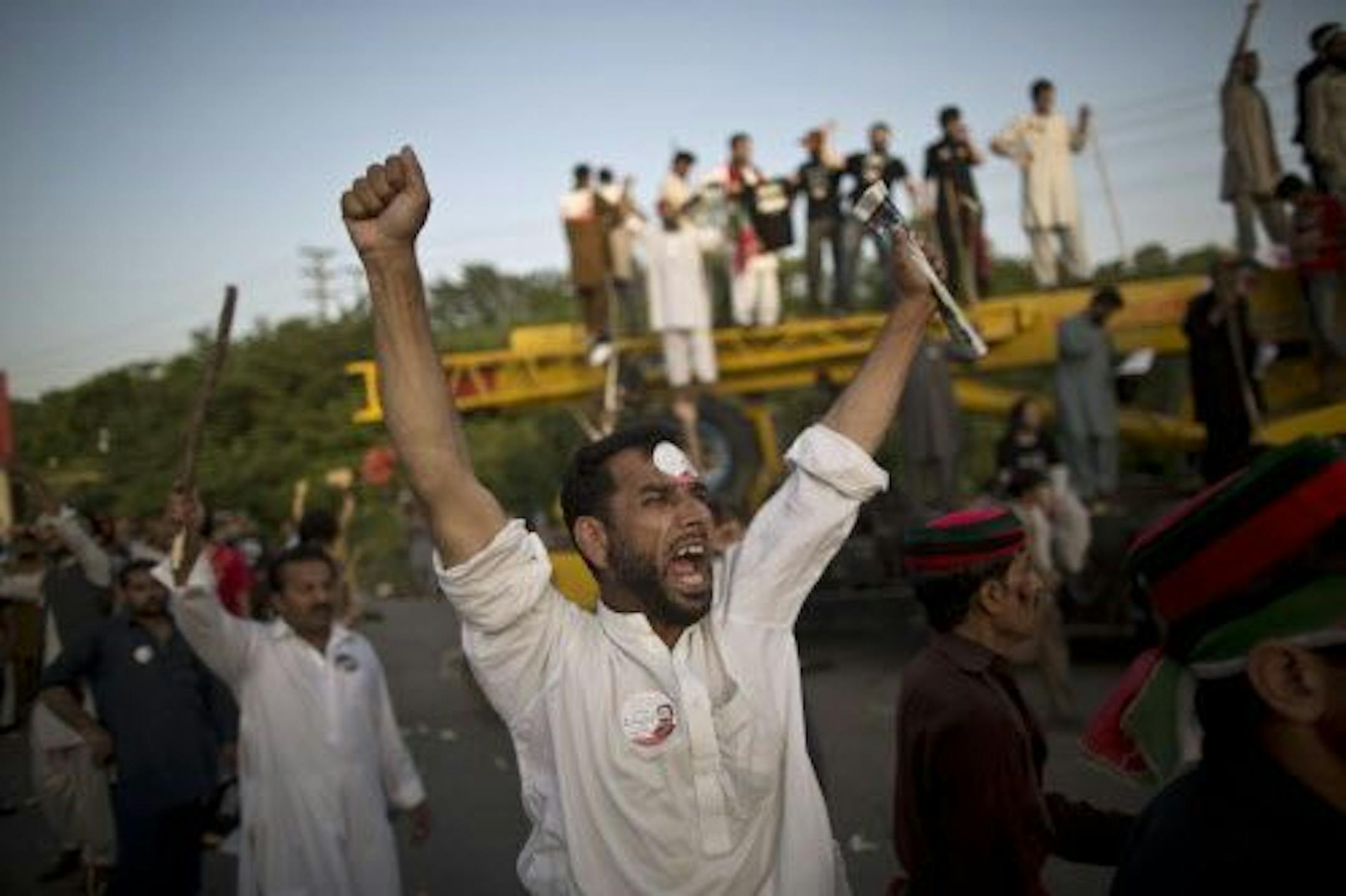 Supporters of Pakistani cricketer-turned-politician Imran Khan shout slogans against Prime Minister Nawaz Sharif, during a protest in Islamabad, Pakistan, Tuesday, Aug. 19, 2014.