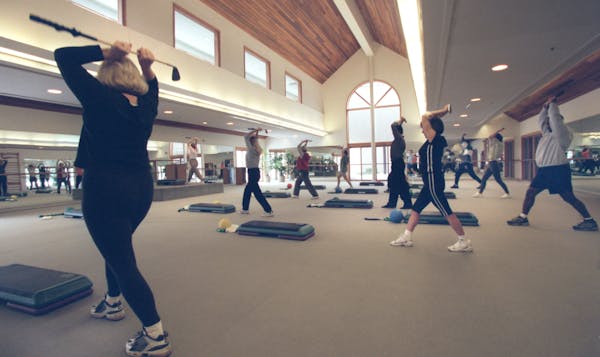 Twelve students stretch during a 2001 golf fitness class at the Marsh.