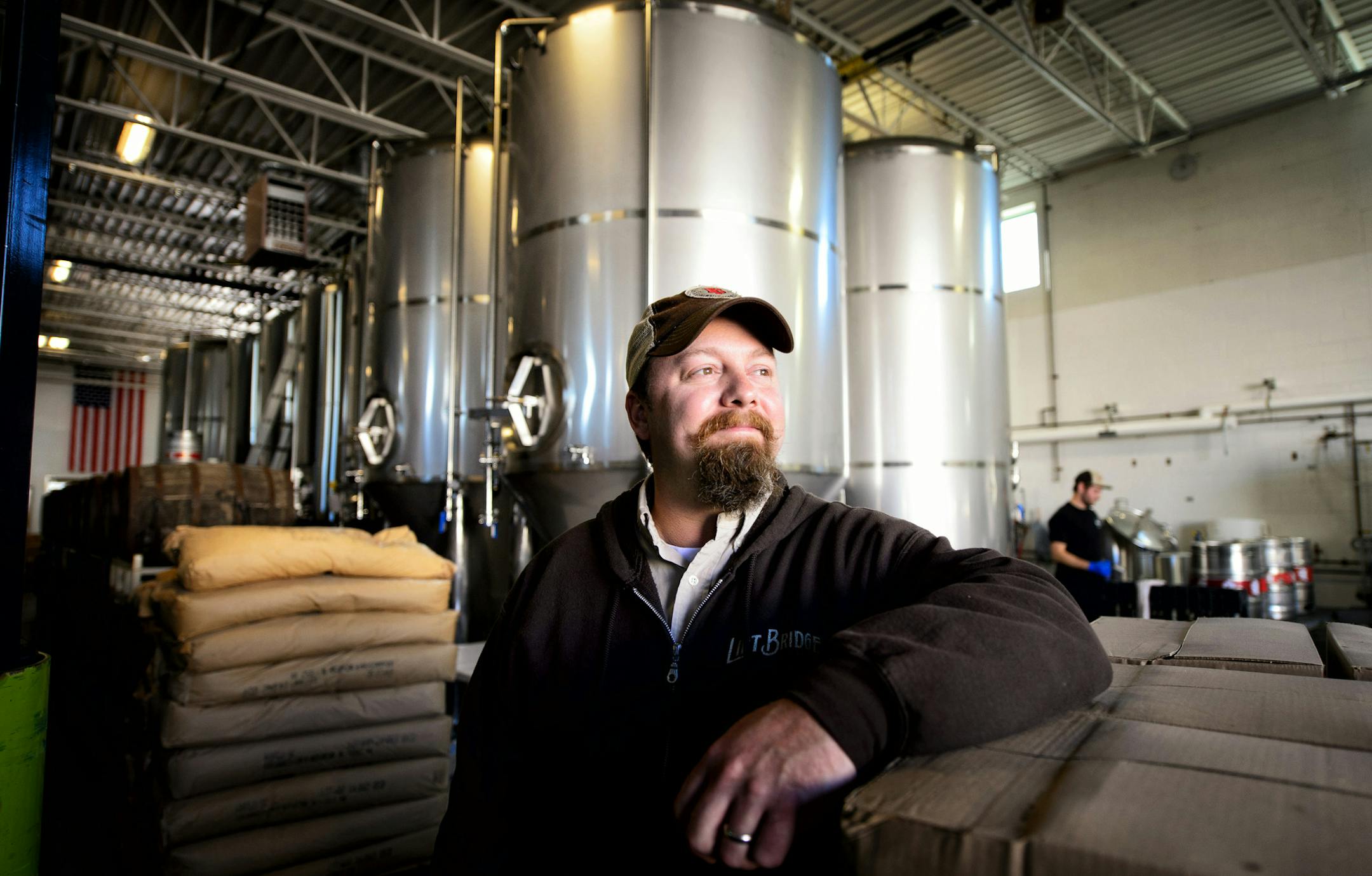 Brad Glynn, co-owner of Lift Bridge. Behind him some of the new tanks along with pre-existing ones. ] GLEN STUBBE * gstubbe@startribune.com Lift Bridge Brewery in Stillwater, MN recently expanded adding five new 60-barrel tanks to expand their production.