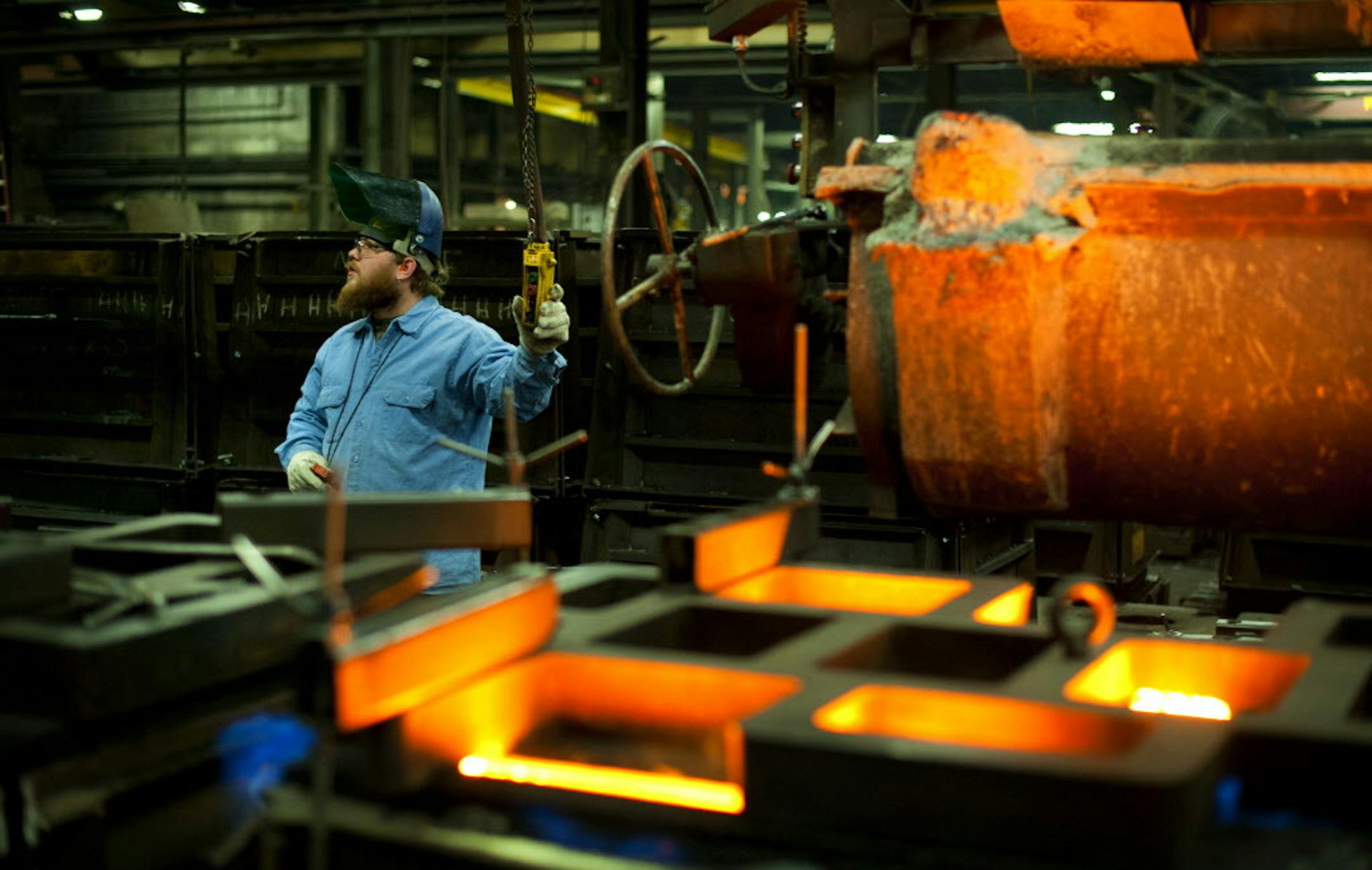 Brandon Smith poured molten iron into sand molds at Badger Foundry in Winona, Thursday, February 16, 2012. The company has been on a hiring spree lately due to an increase in orders. ] GLEN STUBBE * gstubbe@startribune.com EDS: Smith is not a recent hire. KEY WORDS IF USED FOR FILE: manufacturing, hire, hiring, jobs, employee, employees, new, industry, minnesota, workers