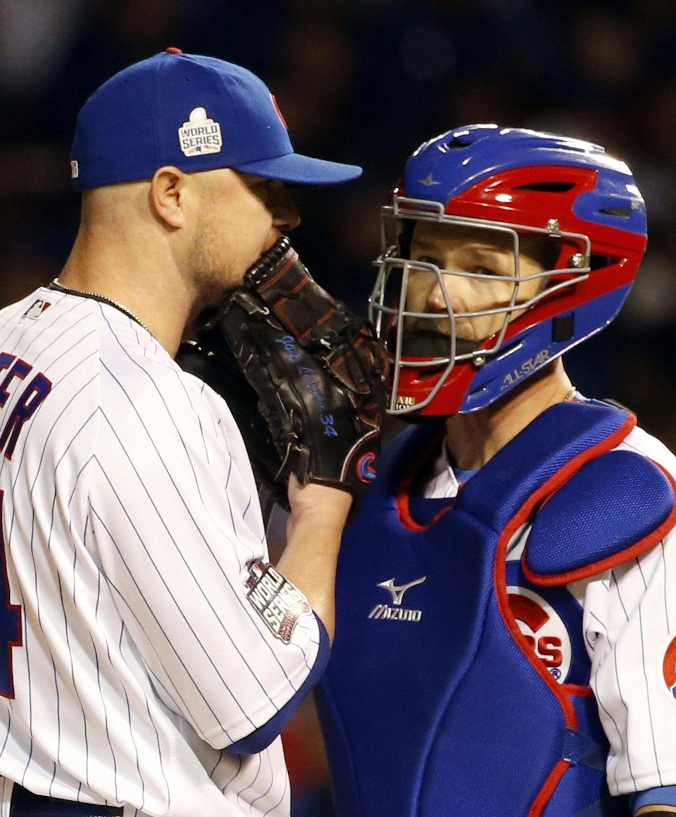 Chicago Cubs starting pitcher Jon Lester (34) talks to catcher David Ross during the fifth inning of Game 5 of the Major League Baseball World Series against the Cleveland Indians, Sunday, Oct. 30, 2016, in Chicago. (AP Photo/Nam Y. Huh)