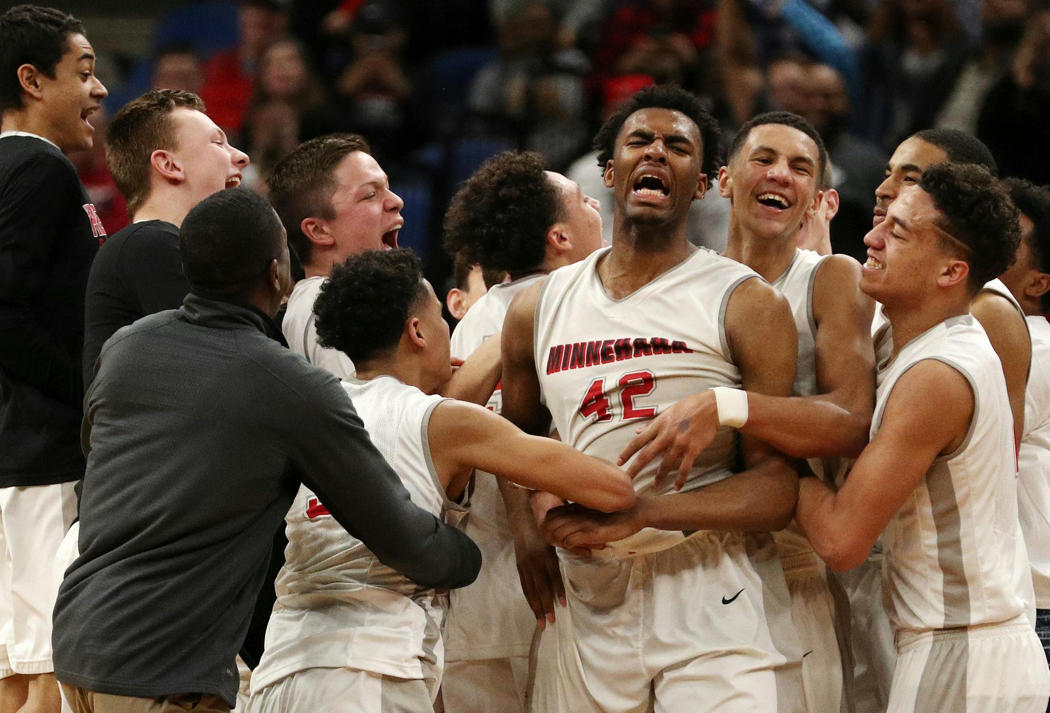 Minnehaha Academy forward JaVonni Bickham (42) was mobbed by his teammates as they celebrated the win. ] ANTHONY SOUFFLE &#xef; anthony.souffle@startribune.com Players competed during the boys' basketball state tournament Class 2A championship game between Cambridge-Isanti High School and Minnehaha Academy Saturday, March 25, 2017 at the Target Center in Minneapolis.