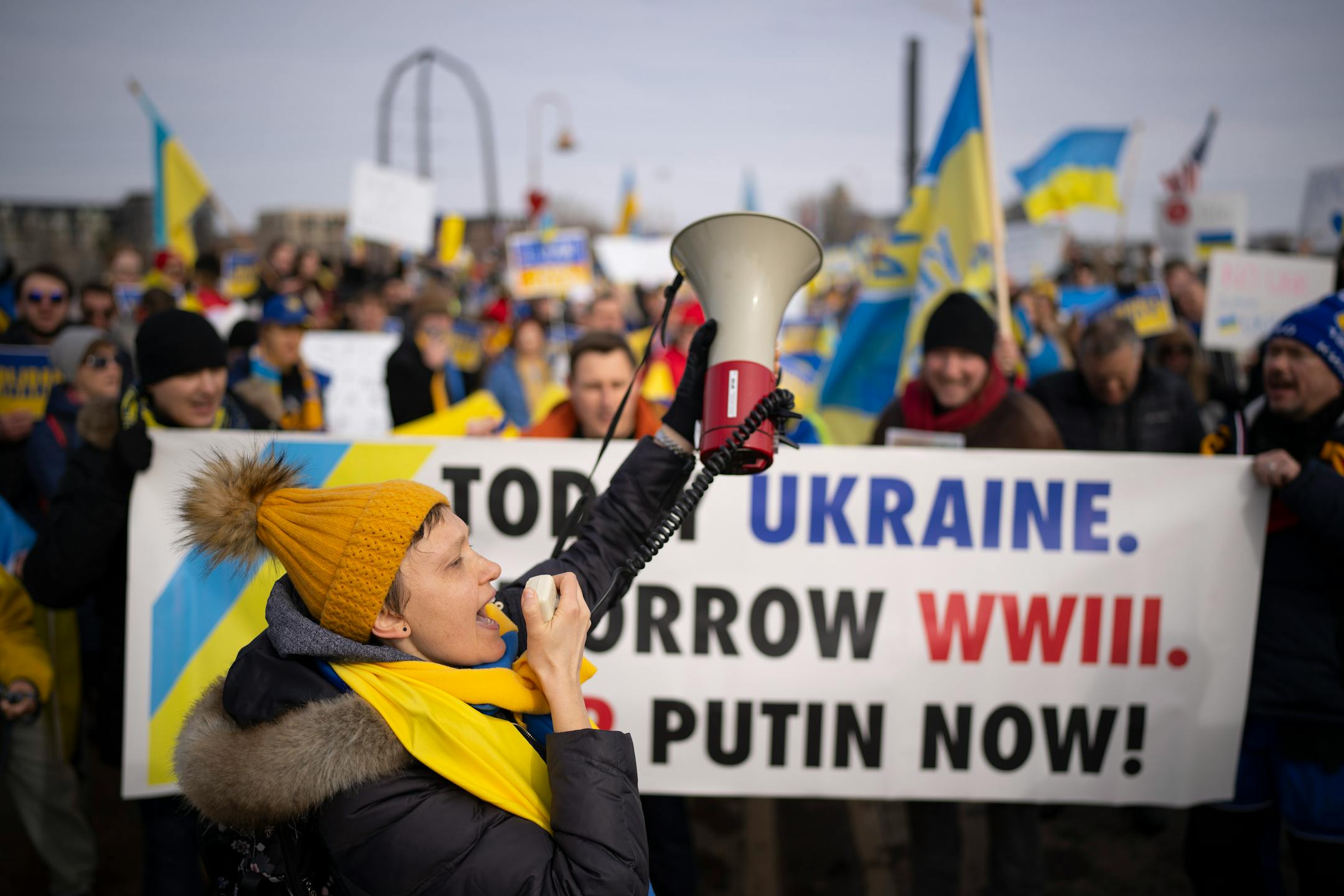 Lyuba Megits led chants with a bullhorn as Ukraine supporters met with a delegation of Belarusians on the Stone Arch Bridge who voiced support for Ukraine Sunday afternoon, February 27, 2022 in Minneapolis, Minn. Hundreds of supporters of the people of Ukraine met a few dozen supporters of the Belarusian people midway across the Stone Arch Bridge in Minneapolis before continuing on a march together across the Hennepin Ave. bridge to Northeast Minneapolis where the march first began. ] JEFF WHEELER • Jeff.Wheeler@startribune.com