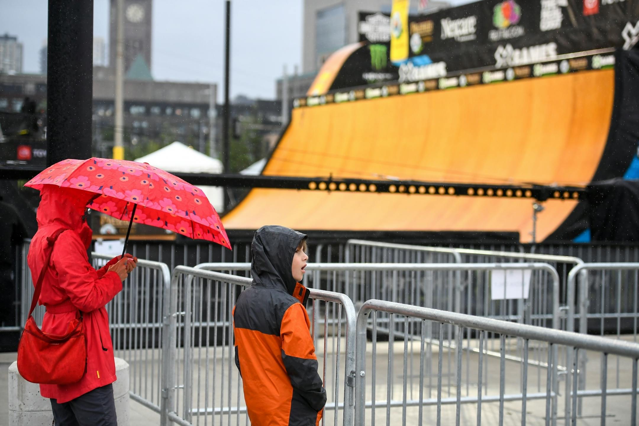 Andrea Murrill, of Minneapolis, and her son Sevi Lewandowski, 8, stood next to the vert ramp as rain began to fall at the X Games Thursday night.
